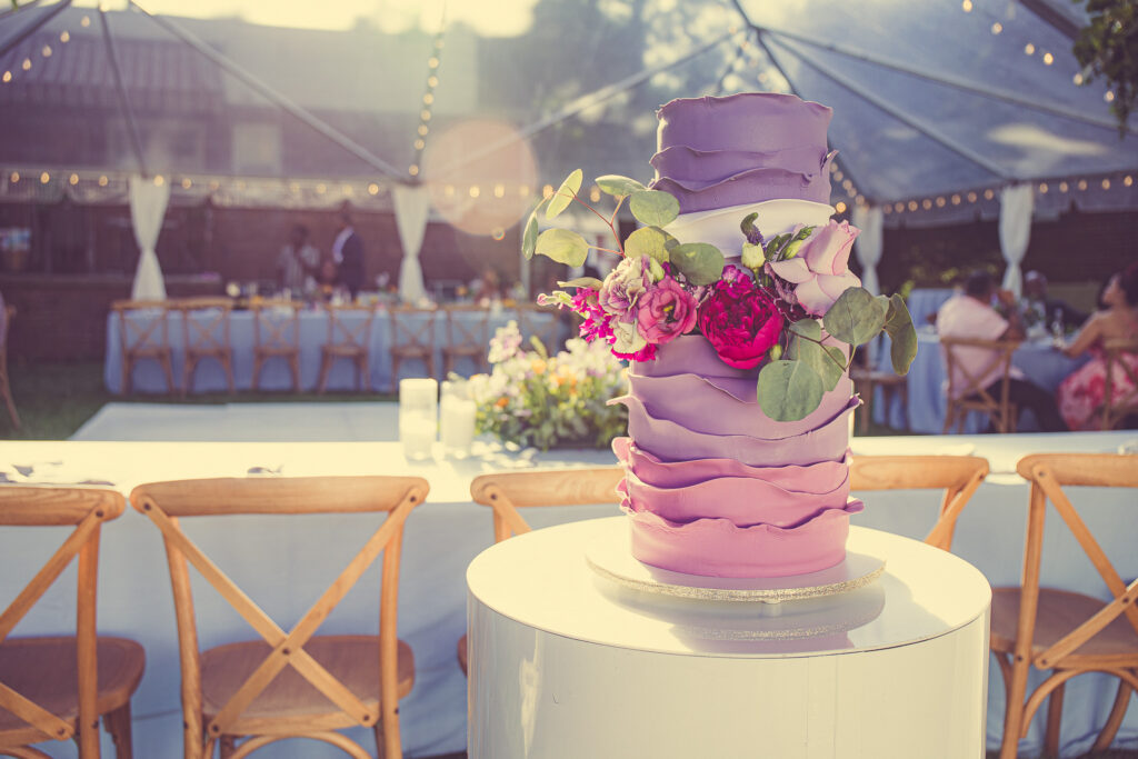 A stunning wedding cake adorned with real flowers and elegant details, a delectable centerpiece for the celebration.