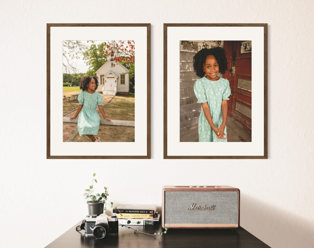Vintage-inspired shelf with a camera and books, flanked by framed photographs of a joyful girl, highlighting the importance of preserving memories through printed images.